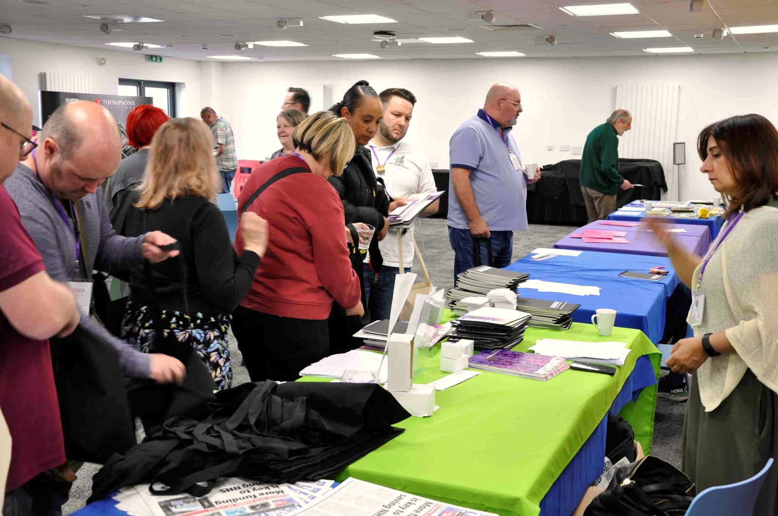 Reps looking through leaflets at conference stalls