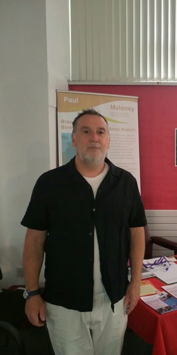A union rep standing by a stall at a Hazards event
